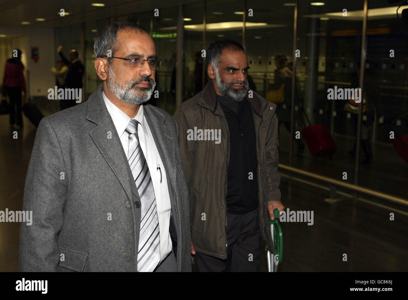 Brothers Soohail (left) and Nasir Shaikh at London's Heathrow Airport as they return from China following an unsuccessful bid to avert the execution of their cousin Akmal Shaikh who was convicted of smuggling 4kg (8.8lb) of heroin into the country. Stock Photo