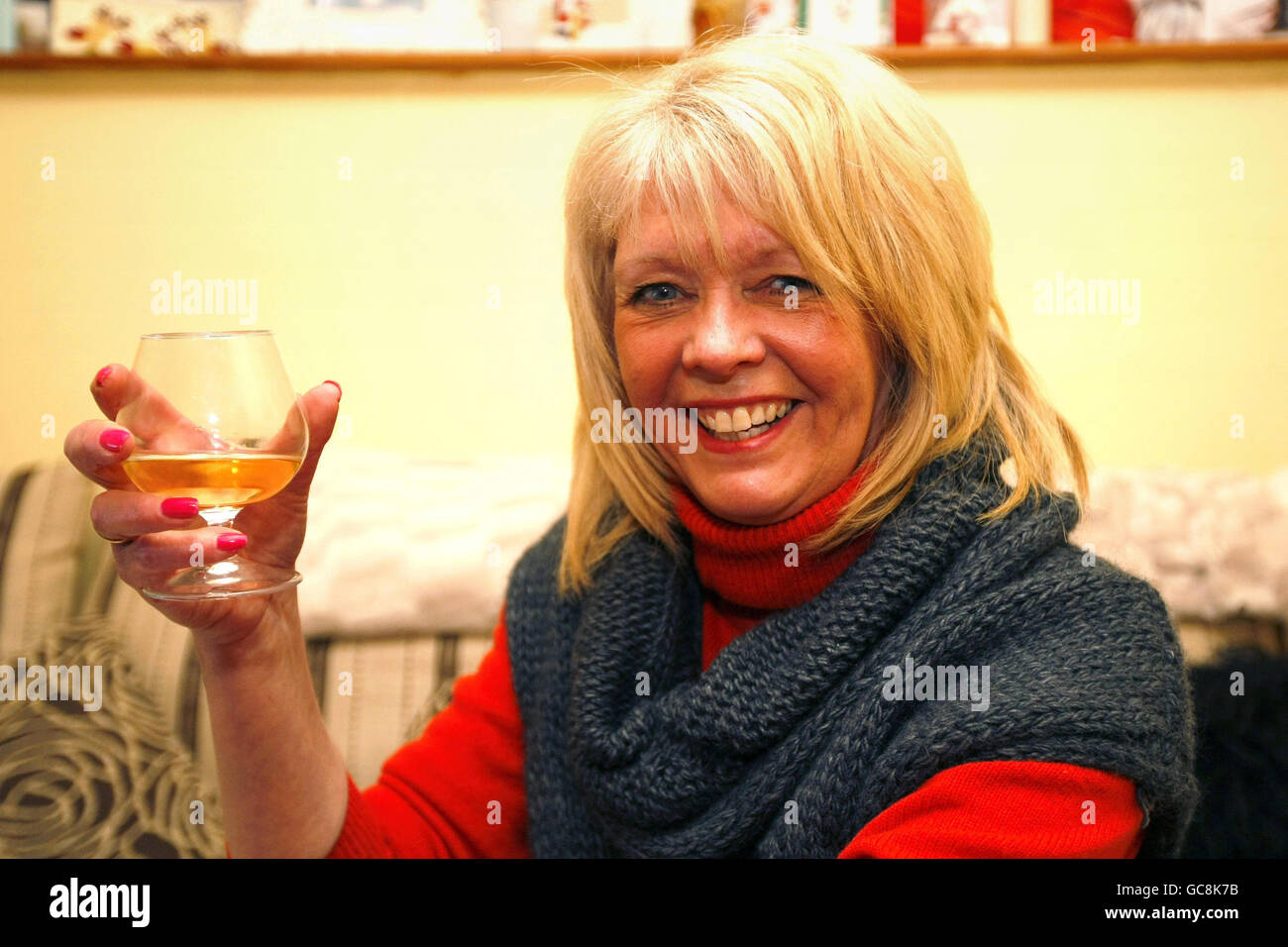 Avril Sweeney toasts the release of her son Peter Moore with a glass of champagne at her home in Thornton Cleavleys, Lancashire. Stock Photo