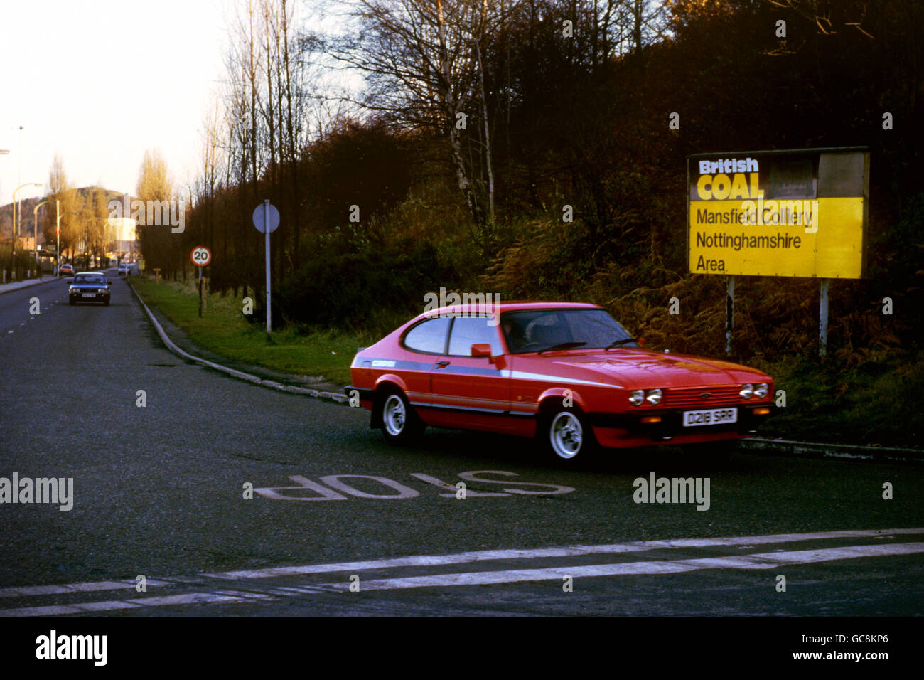 A miner in a Ford Capri leaves Mansfield Colliery, Nottinghamshire, which closed in 1988. Stock Photo