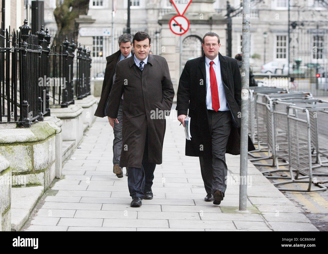 Finance Minister Brian Lenihan (centre) walks along Molesworth Street in Dublin after briefing the media on his medical condition. Lenihan confirmed he would undergo treatment to remove cancerous tissue in his pancreas. Stock Photo