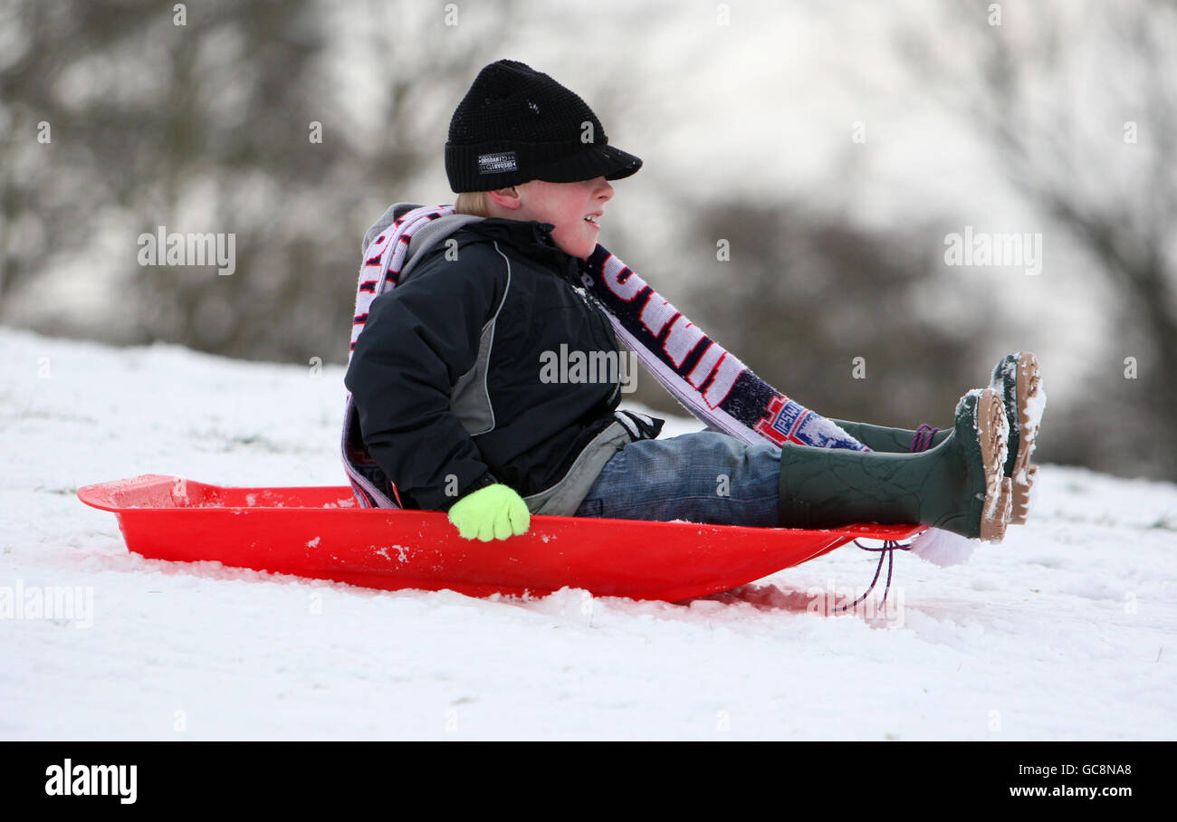 Zak Gissing, enjoys a day off school sledging at Christchurch Park in the centre of Ipswich, Suffolk. Stock Photo