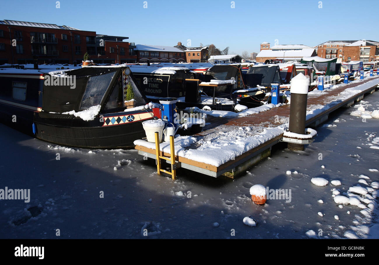 Boat moored at Diglis Basin in Worcester are stranded in the frozen canal water after a severe frost in Worcester overnight. Stock Photo