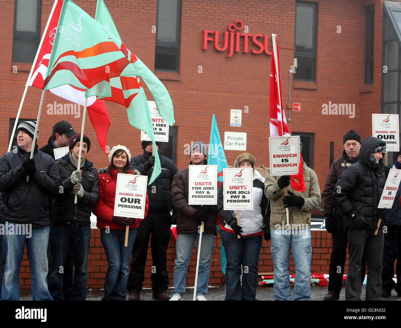 Workers stand outside the Fujitsu offices on the Holywood road in Belfast, where they are striking against proposals for redundancies, a pay freeze and plans by the company to close the main final salary pension scheme to new workers. Stock Photo