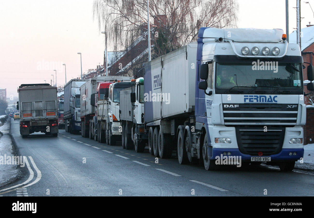 Trucks queue for grit outside British Salt, in Middlewich, Cheshire, as stocks across the UK near depletion. Stock Photo