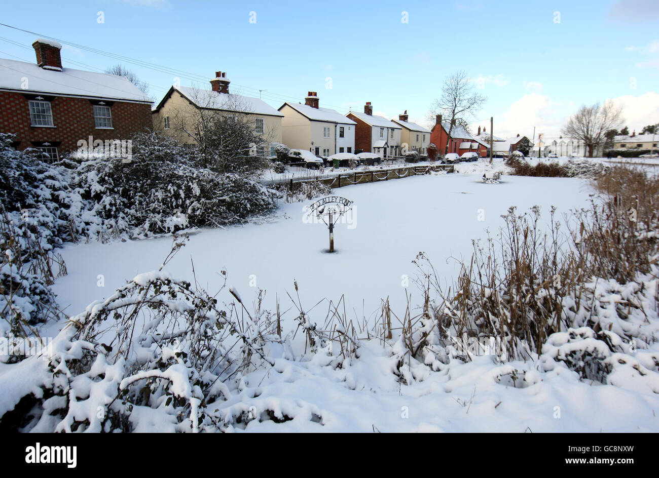 A frozen over pond in Attlebrough, Norfolk during the winter weather. Stock Photo