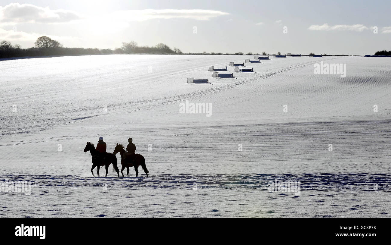 Horse Racing - Snow Covered Gallops at Malton. Horses ride on the snow covered gallops at Malton. Stock Photo