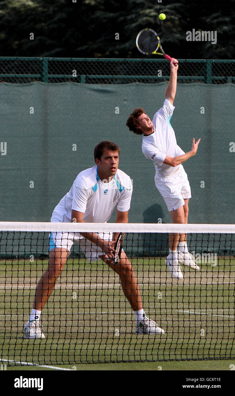 Great Britain's Jamie Murray (back) serves during his doubles match with partner Luxemburg's Gilles Muller against USA's Robert Kendrick and Jesse Levine (not pictured) Stock Photo