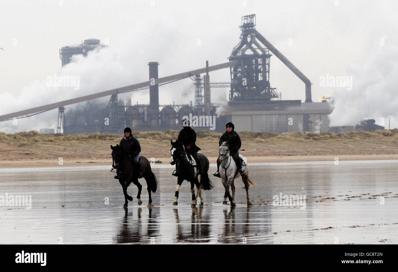 As temperatures rise and the prospect of Turf racing increases many Northern trainers are keeping their horses fit on Redcar beach. Stock Photo