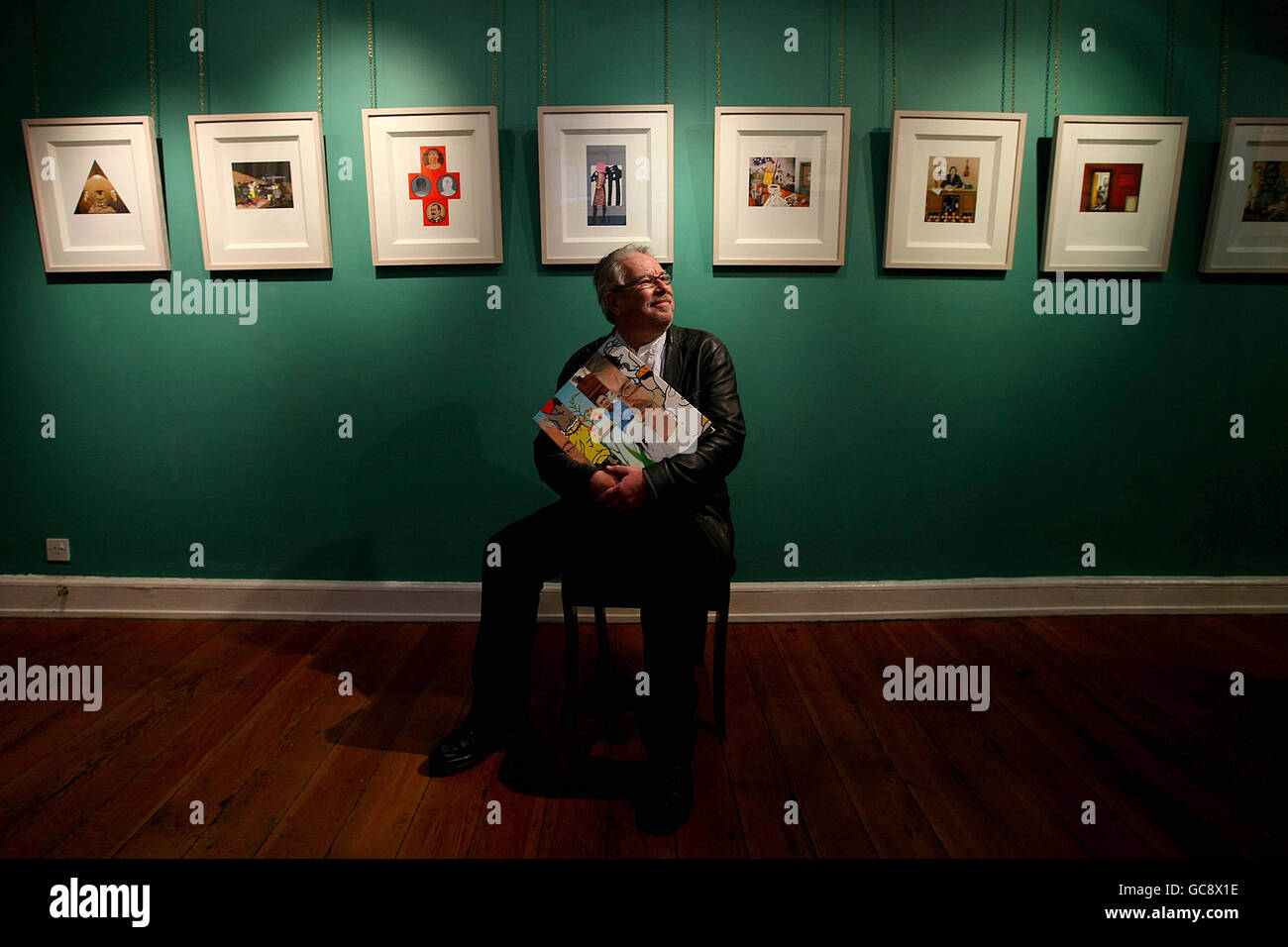 Celebrated Irish Artist Robert Ballagh sits in the Gorry Gallery, Dublin, holding a copy of his biography containing original art works and costing 2,500 Euro each. Stock Photo