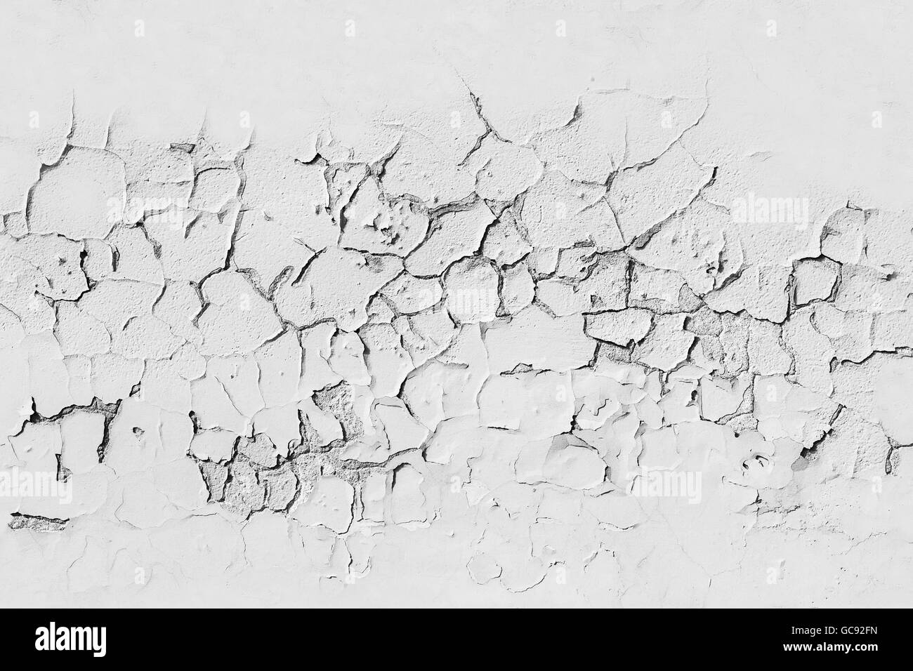 White concrete wall with cracked flaking paint layer, background texture with seamless composition Stock Photo