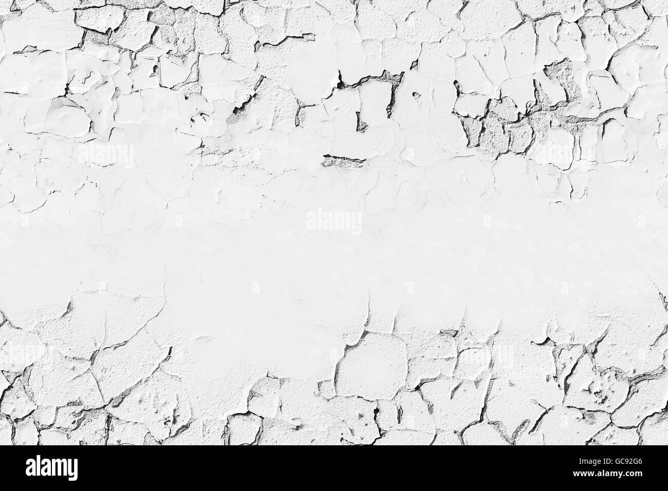 White concrete wall with cracked flaking paint layer, background texture with seamless composition and copy-space Stock Photo