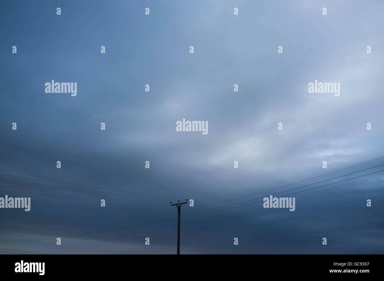 Power lines against a blue sky Stock Photo - Alamy