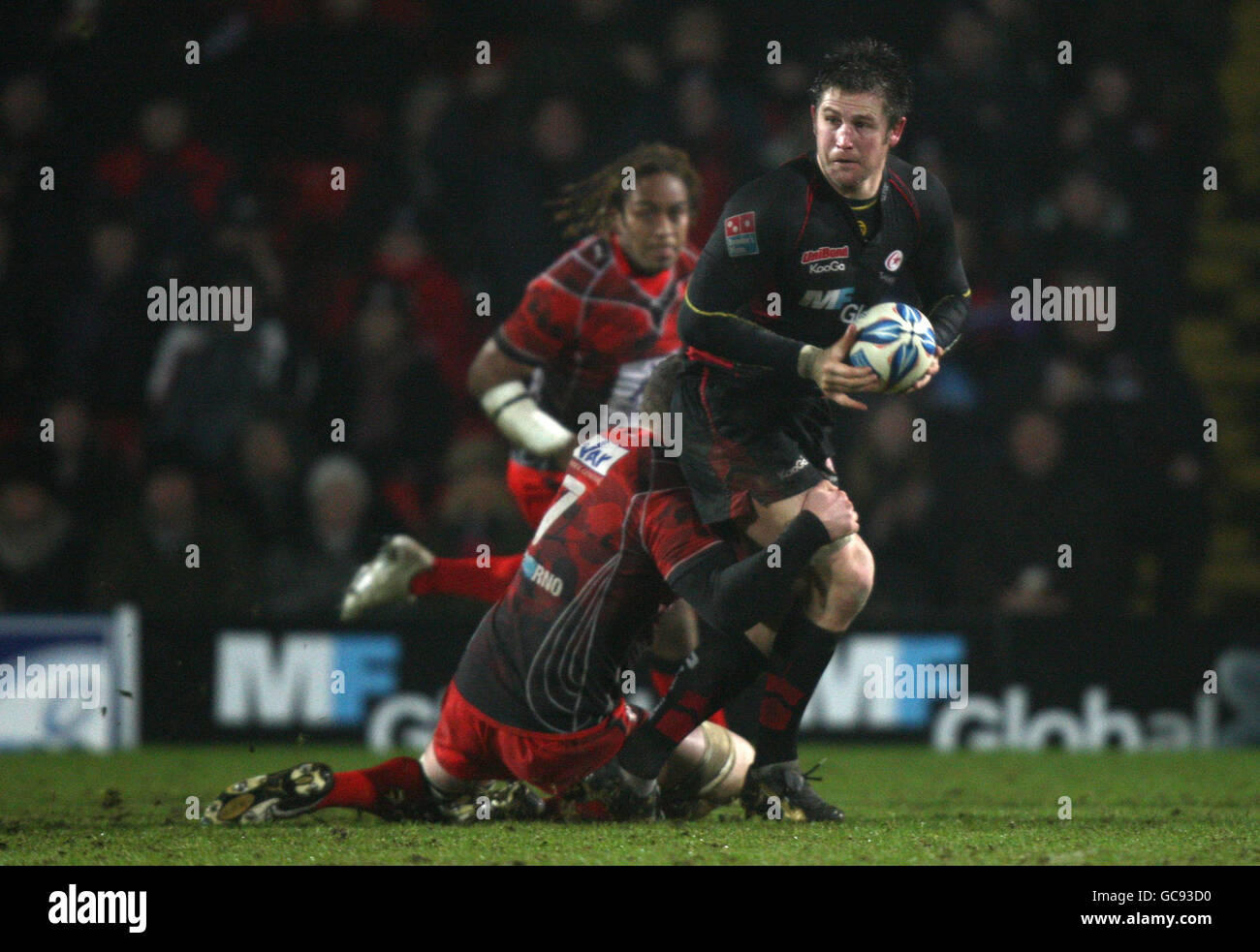 Saracens' Ernst Joubert is tackled by Toulon's Cedric Beal during the Amlin Challenge Cup match at Vicarage Road Stadium, Watford. Stock Photo