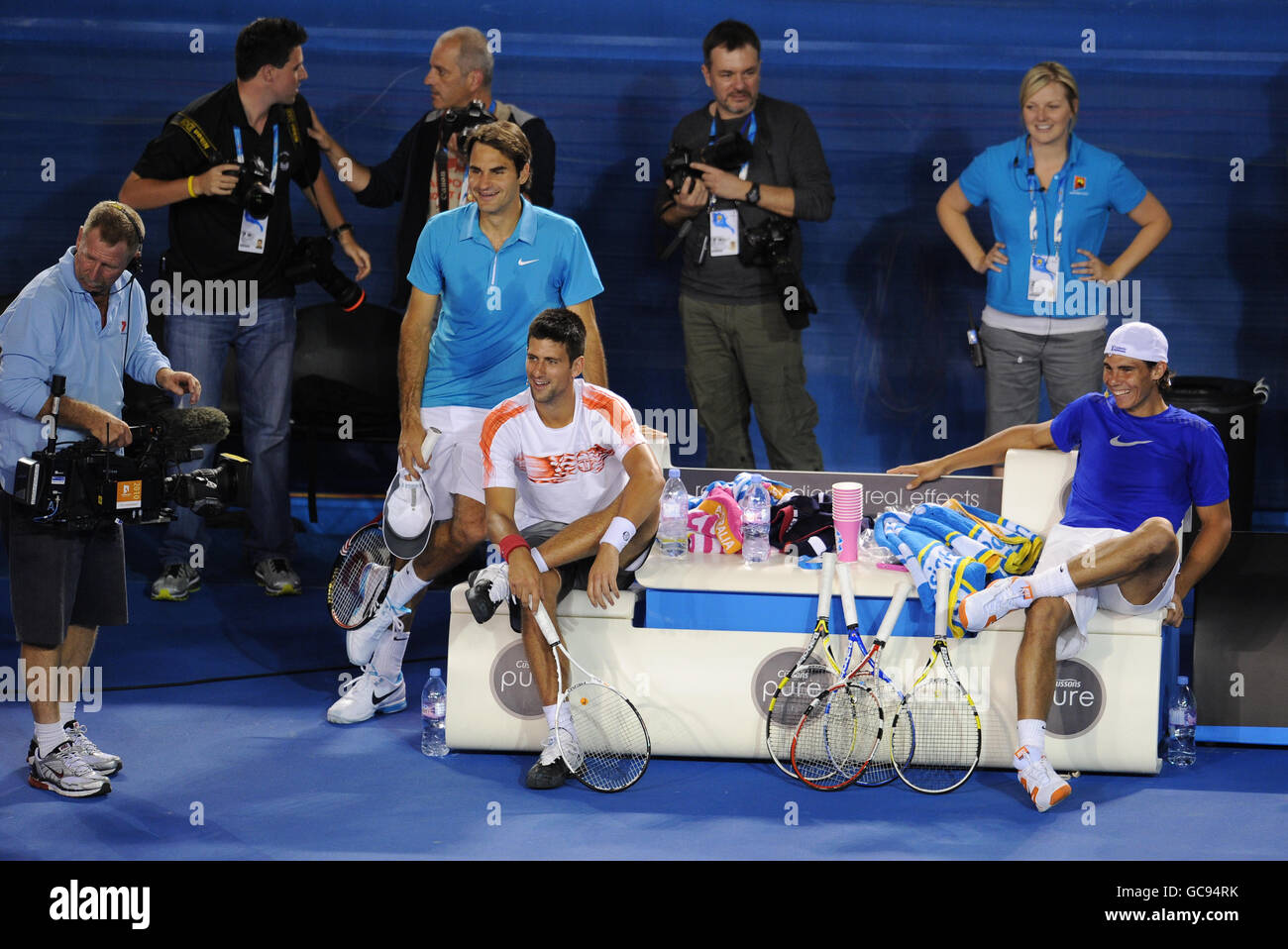 Roger Federer, Novak Djokovic and Rafael Nadal relax and watch their  respective teamates during a fundraising "Hit for Haiti" organised by Roger  Federer to support the victims of the Haiti earthquake Stock
