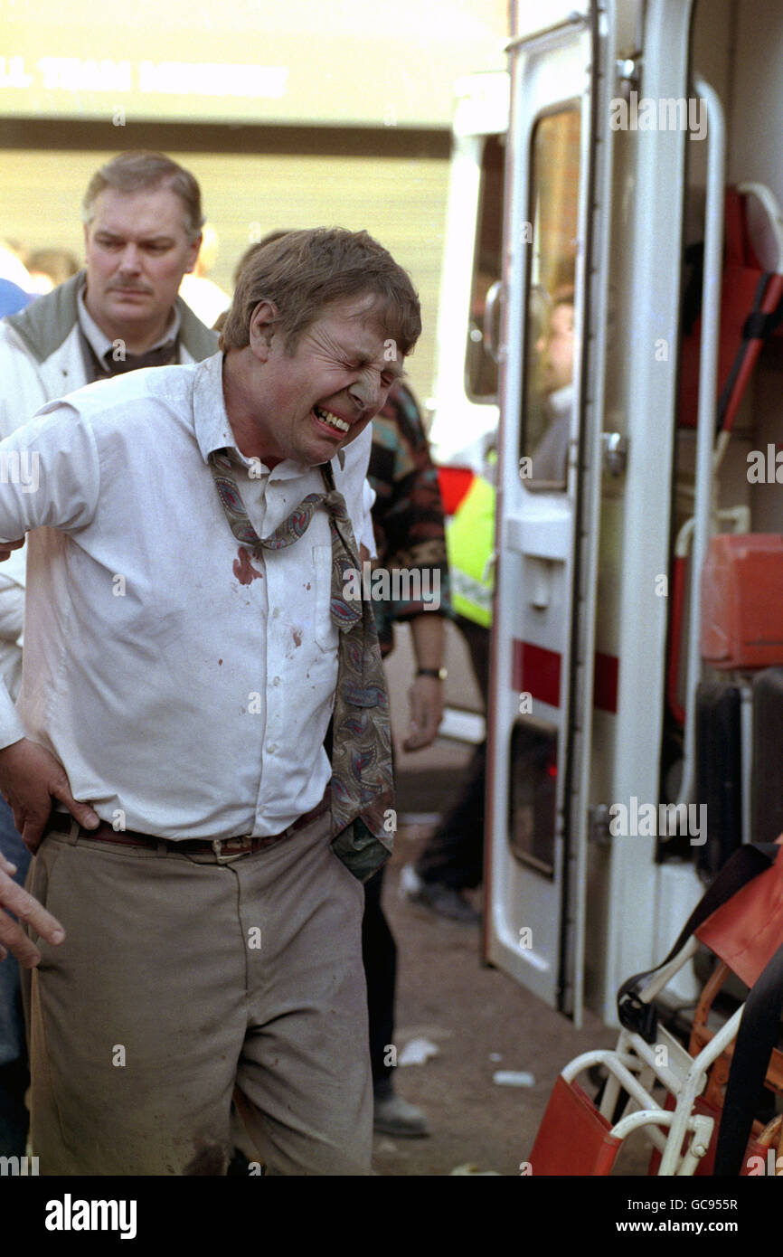AN INJURED MAN IS BROUGHT TO A WAITING AMBULANCE AFTER AN EXPLOSION AT THE OLD UDA HEADQUARTERS IN SHANKILL ROAD. Stock Photo