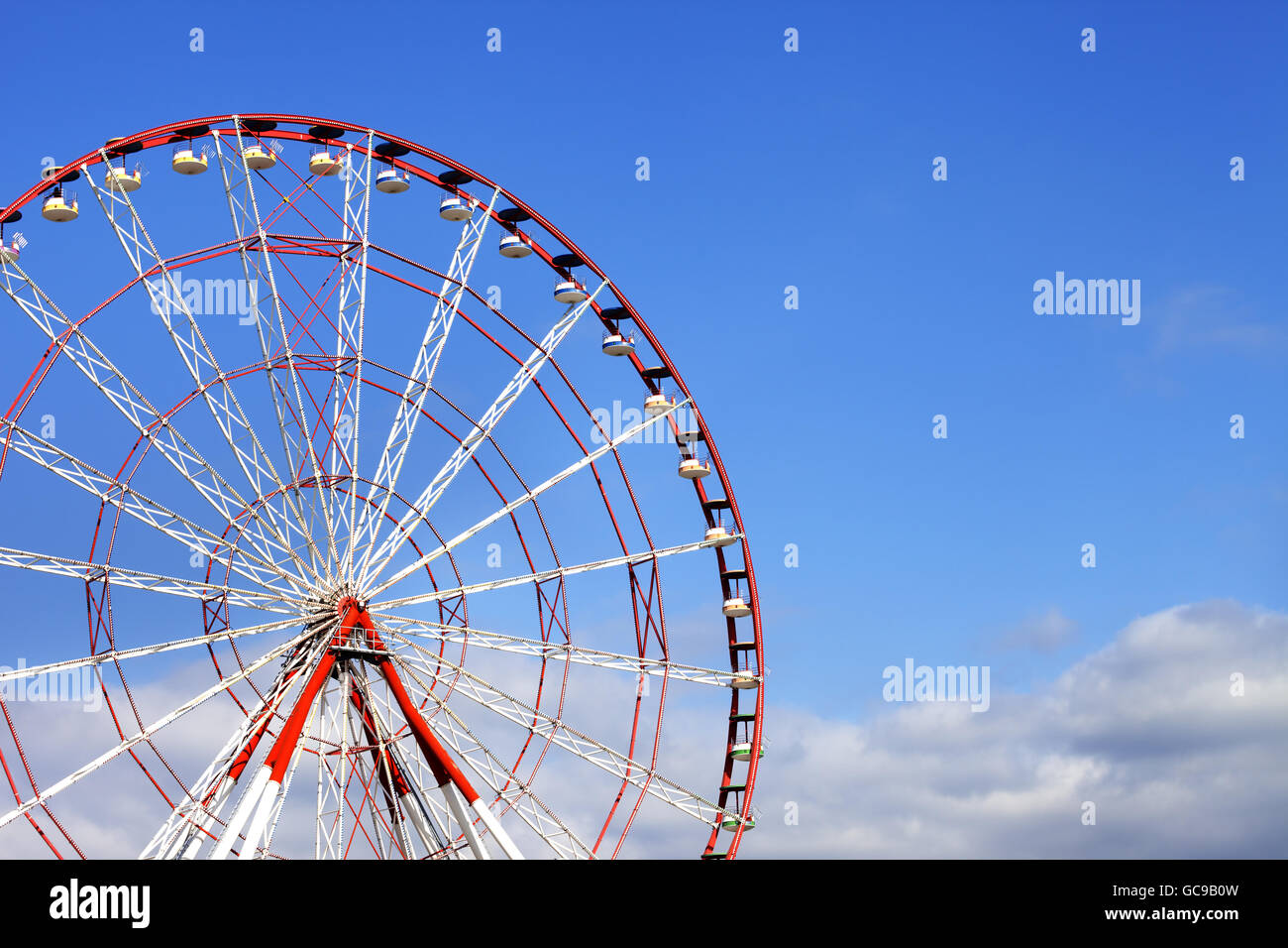 Ferris wheel and blue sky with clouds in sun day Stock Photo - Alamy