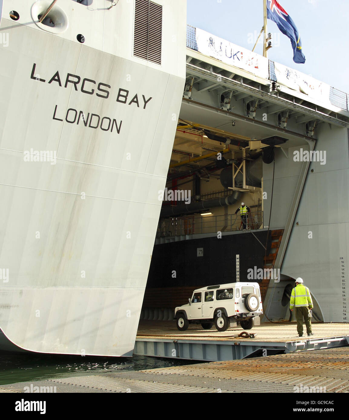 A Land Rover, part of a cargo of humanitarian aid bound for Haiti, being loaded onto the Royal Fleet Auxiliary (RFA) Largs Bay at the Sea Mounting Centre in Marchwood near Southampton. Stock Photo