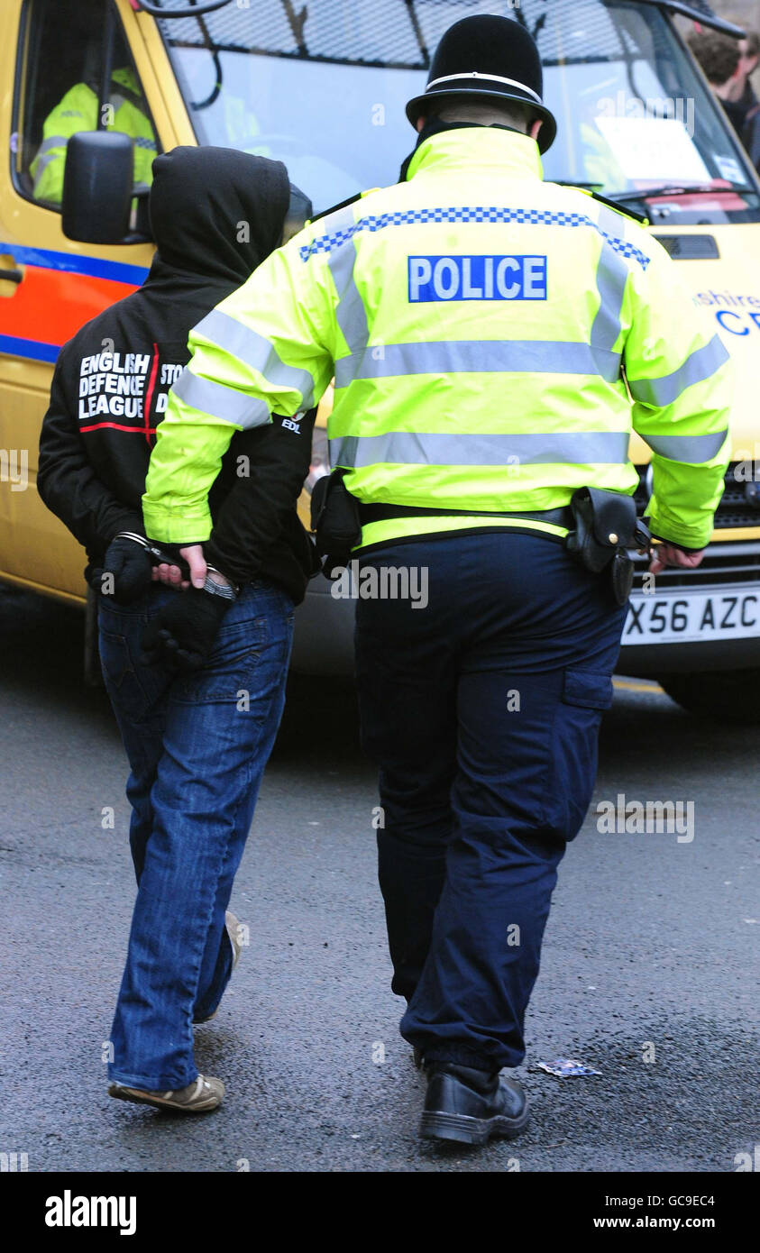 A member of the English Defence League is led away by police during a demonstration against militant Islam today. Stock Photo