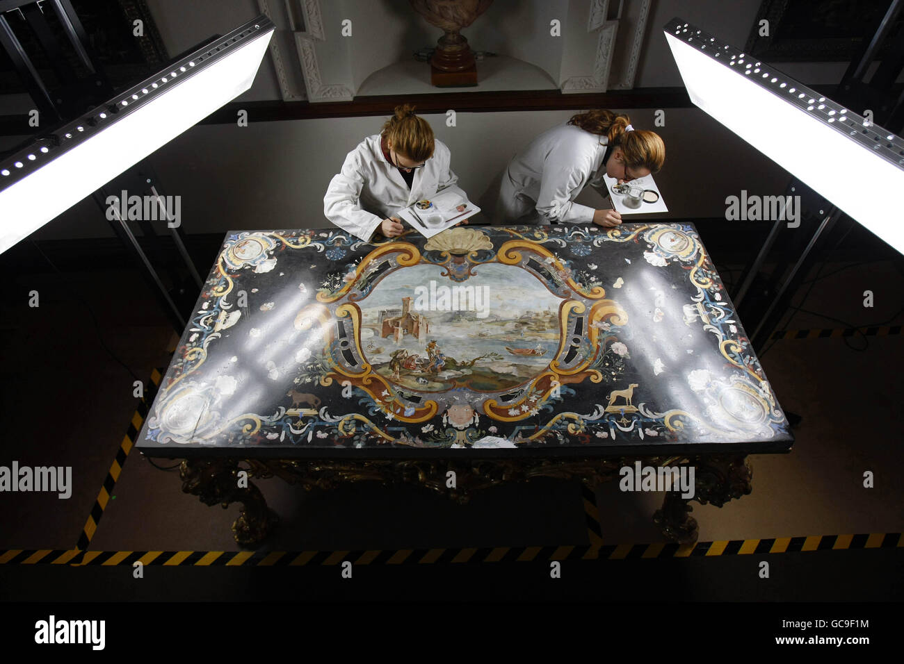 Conservators Francesca Toso, left, and Chiara Martinelli of the Opificio delle Pietre Dure, in Florence, finish restoration work on one of three eighteenth-century scagliola console table-tops, at Russborough House, in Co Wicklow. Stock Photo