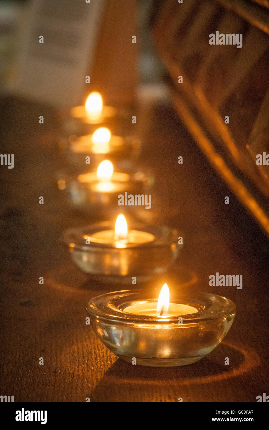 Tea light candles in a row Stock Photo