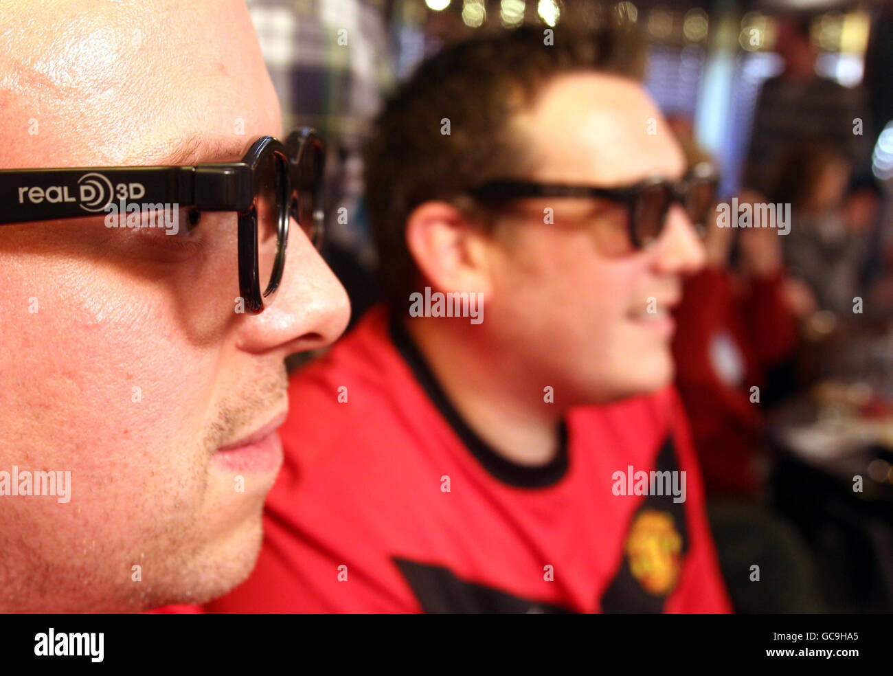 Manchester United fans watch their team in the world's first live 3D TV sports broadcast football match against Arsenal in the Red Lion pub in Withington, Manchester. Stock Photo