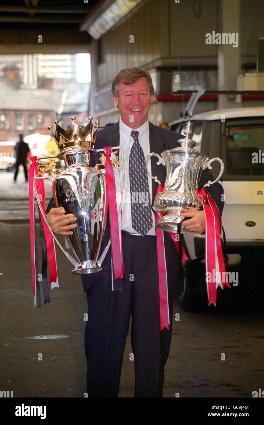 Manchester United manager Alex Ferguson with the FA Cup and Premier League trophy as Manchester United return for a homecoming victory parade. Stock Photo