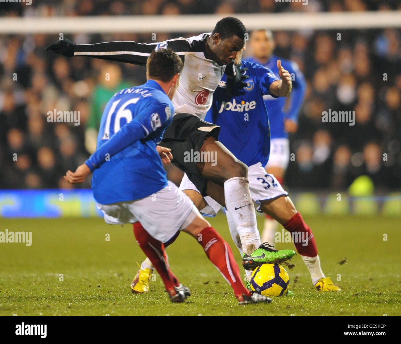 Fulham's Stefano Okaka Chuka and Portsmouth's Hassan Yebda battle for the ball Stock Photo