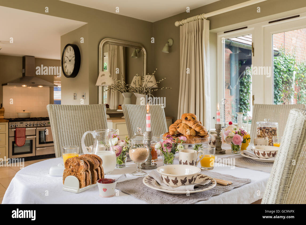 Table laid with breakfast croissant and toast. The dining chairs are