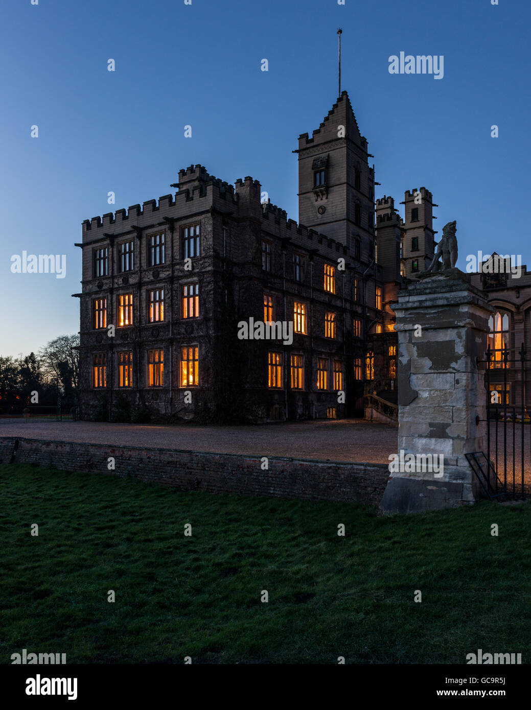 Night time view of exterior facade building,  architecture Grade I Listed building Victorian Gothic stately home Stock Photo