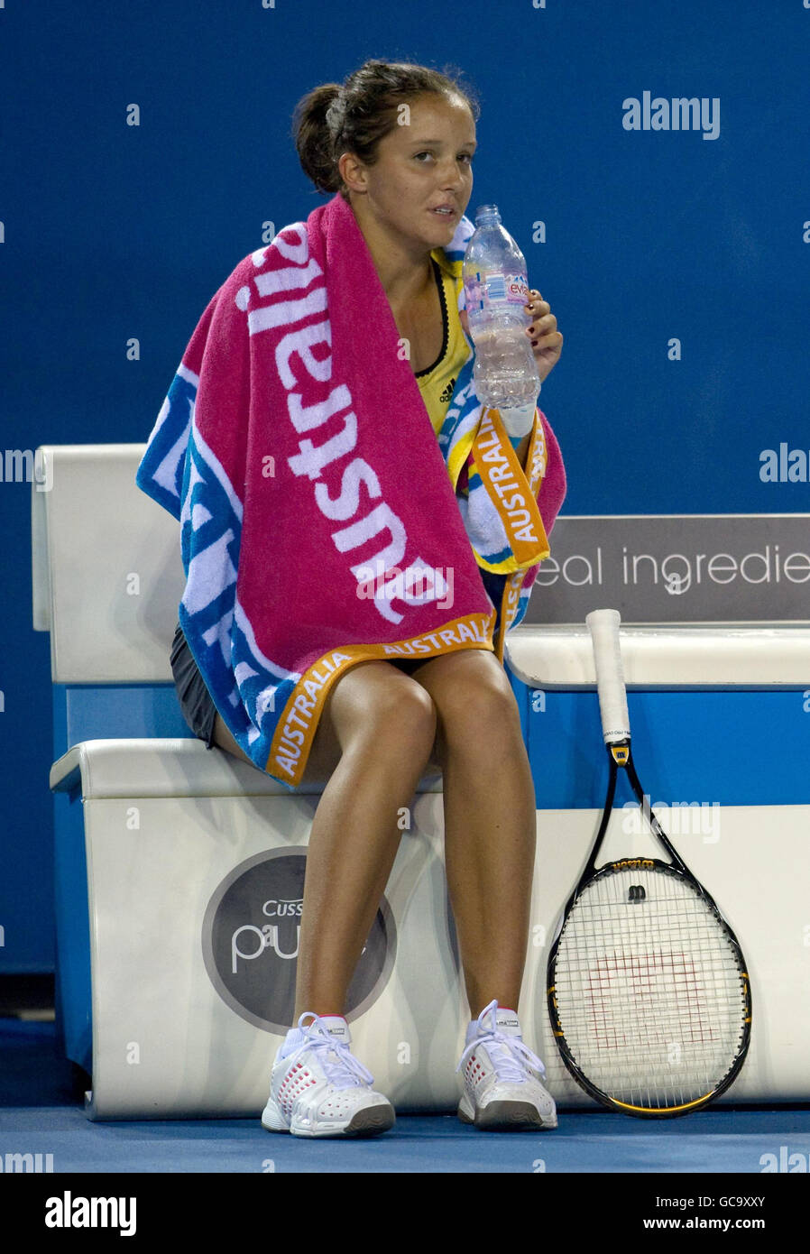 Great Britain's Laura Robson keeps warm with a towel in her doubles match with Australia's Sally Peers against Russia's Maria Kirilenko and Poland's Agnieszka Radwanska during The Australian Open at Melbourne Park at Melbourne Park, Melbourne. Stock Photo