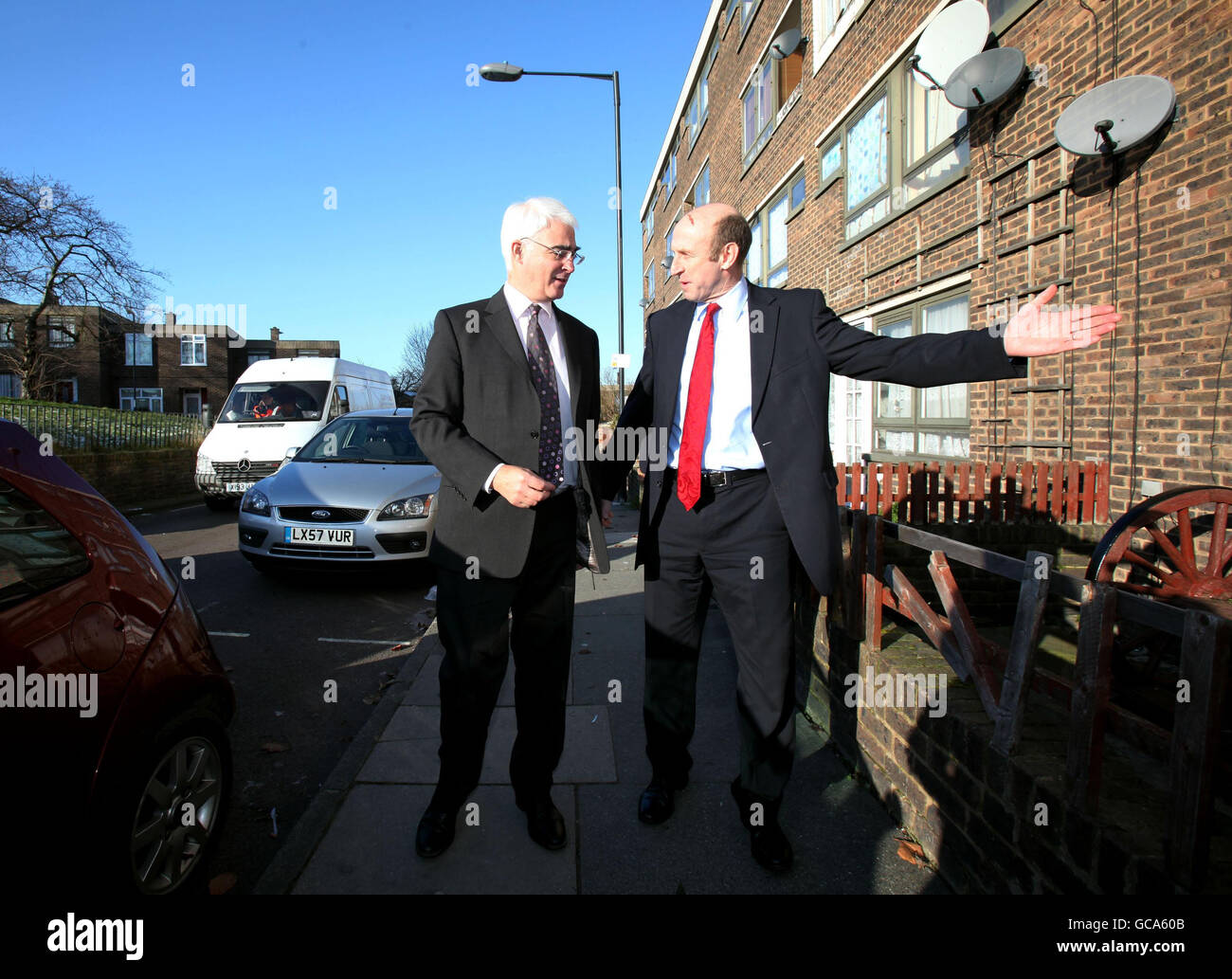 Chancellor Alistair Darling and Housing Minister John Healey (right) visit the home of Paul Rice and Margaret MacMann, who were the first in London to benefit from the mortgage rescue scheme, in Plumstead, London. Stock Photo