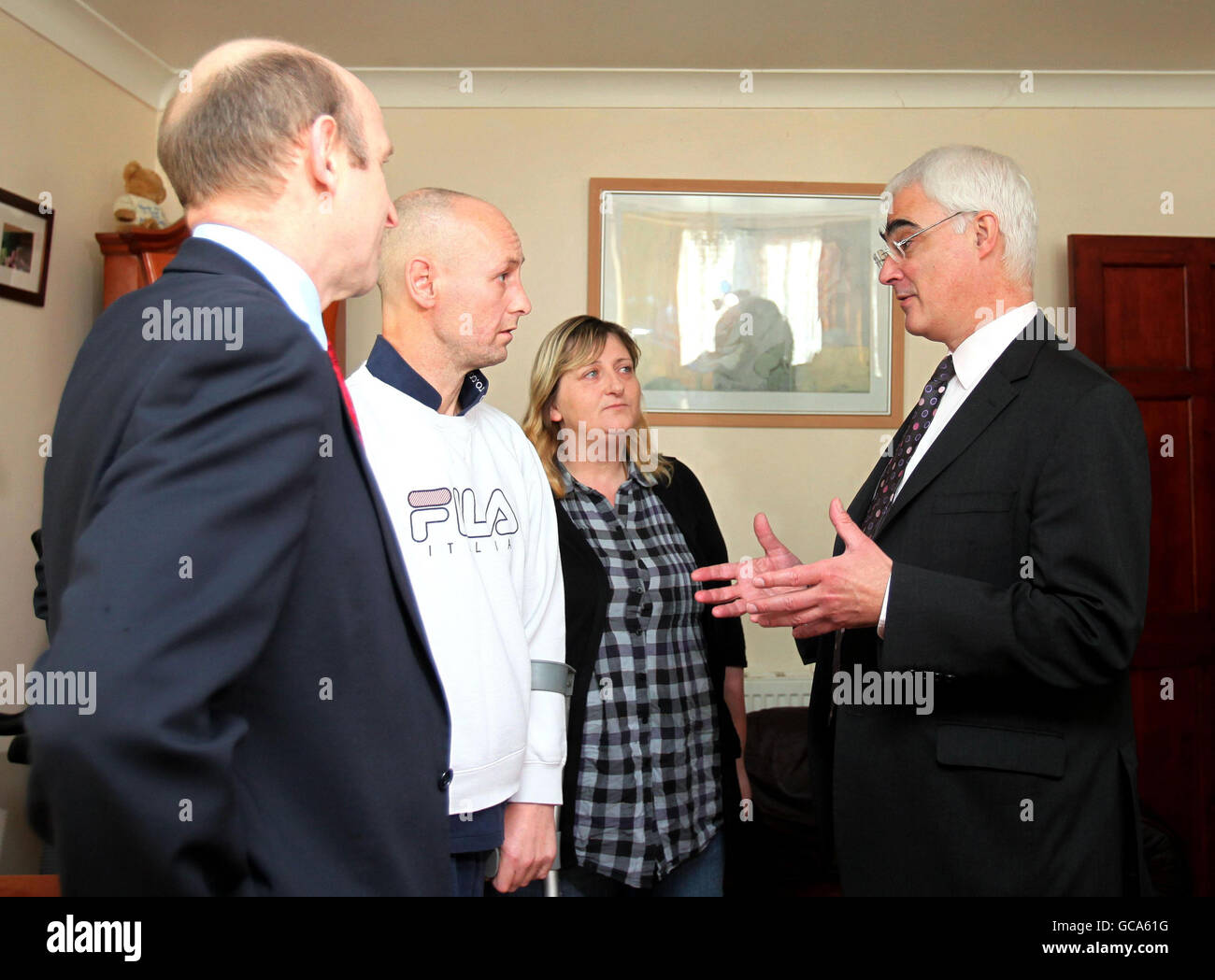 Chancellor Alistair Darling (right) and Housing Minister John Healey (left) visit the home of Paul Rice and Margaret MacMann, who were the first in London to benefit from the mortgage rescue scheme, in Plumstead, London. Stock Photo