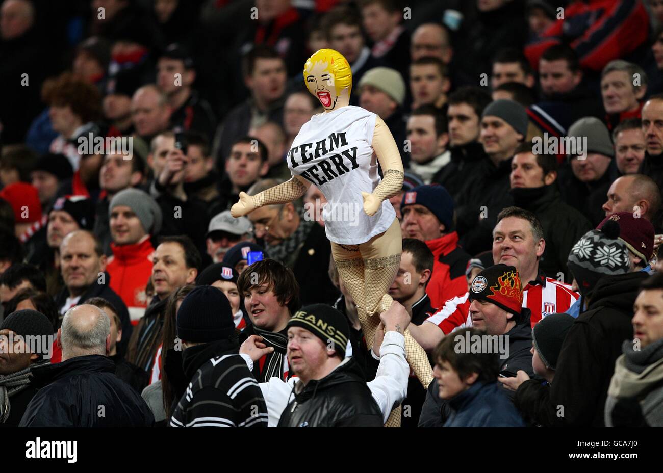 Soccer - FA Cup - Fifth Round - Manchester City v Stoke City - City of Manchester Stadium. Stoke City fans hold up a blow up doll wearing a team Terry t-shirt in the stands Stock Photo