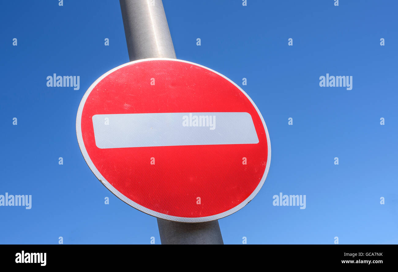 No entry sign on a pole pictured against a bright blue sky in Blackpool, Lancashire, UK Stock Photo