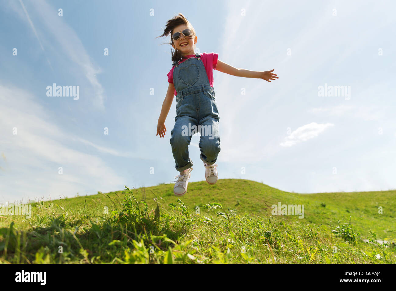 happy little girl jumping high outdoors Stock Photo - Alamy