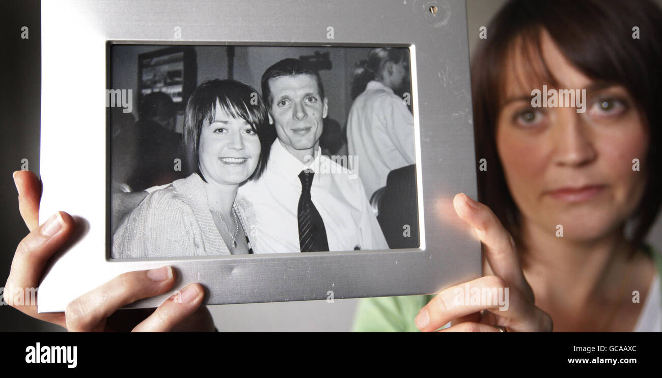 Caroline McIntyre, the widow of champion cyclist Jason McIntyre, holds a photograph of the two of them at Thompsons Solicitors in Glasgow. Stock Photo