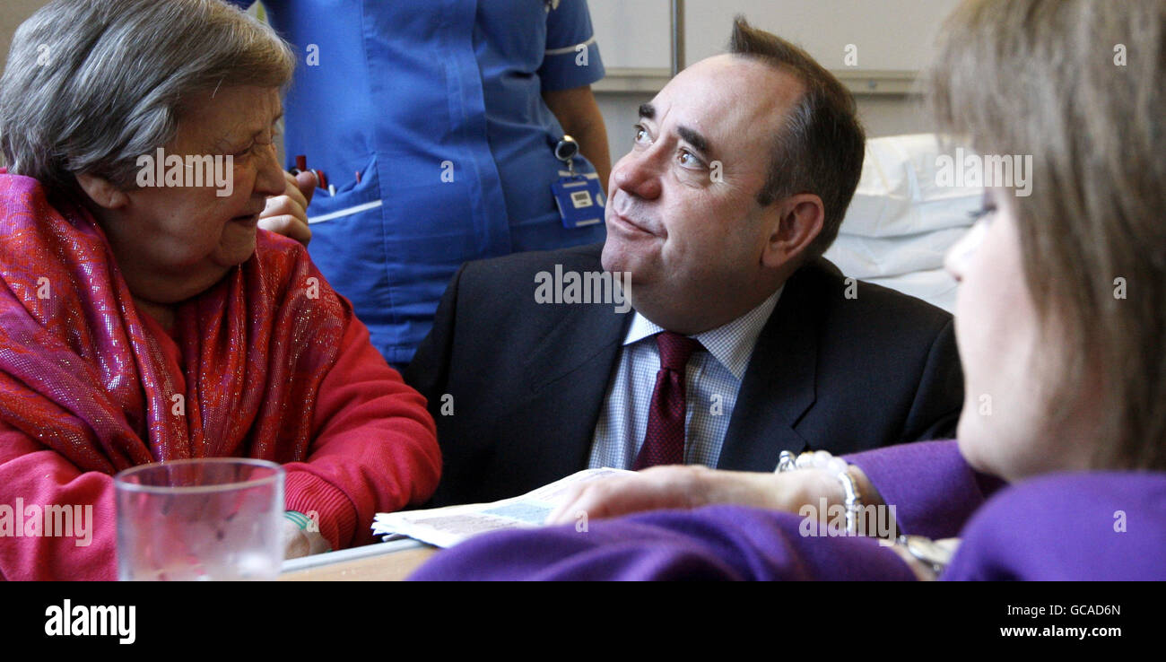 Scottish First Minister Alex Salmond and Health Secretary Nicola Sturgeon (right) chat to patient Florence Gilmour (left) during a visit to officially open the New Victoria Hospital in Glasgow. Stock Photo