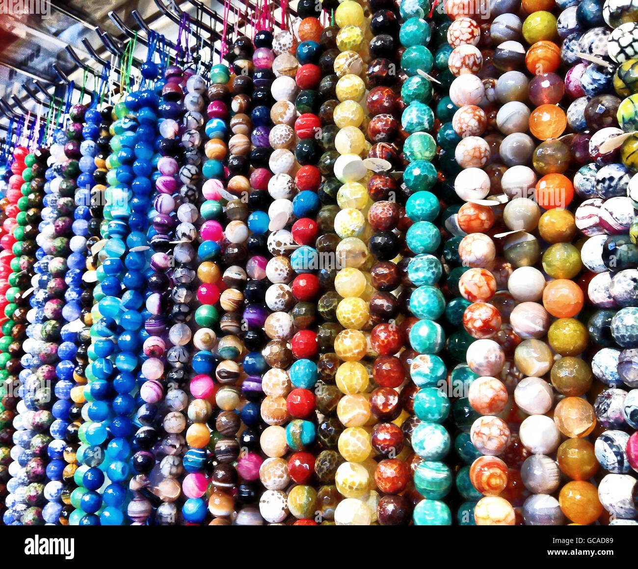 Strands of beads of semi precious stones at a bead shop. Stock Photo