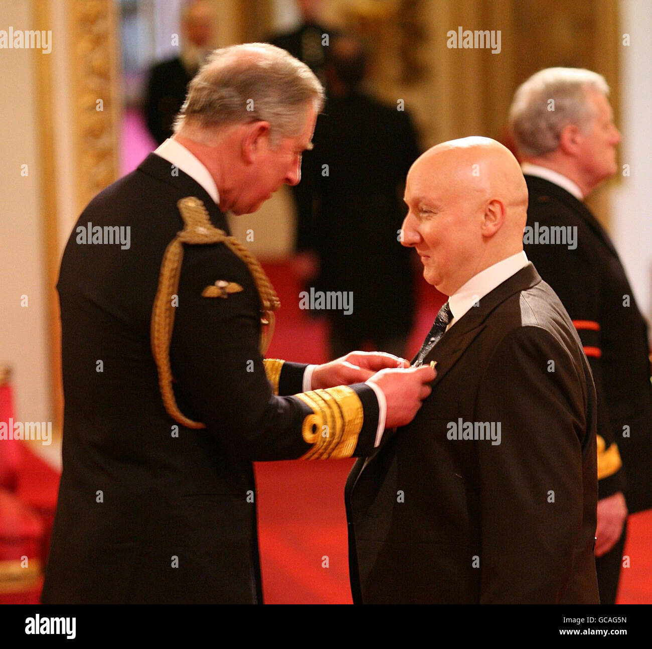 Milliner Stephen Jones receives an OBE from the Prince of Wales during 