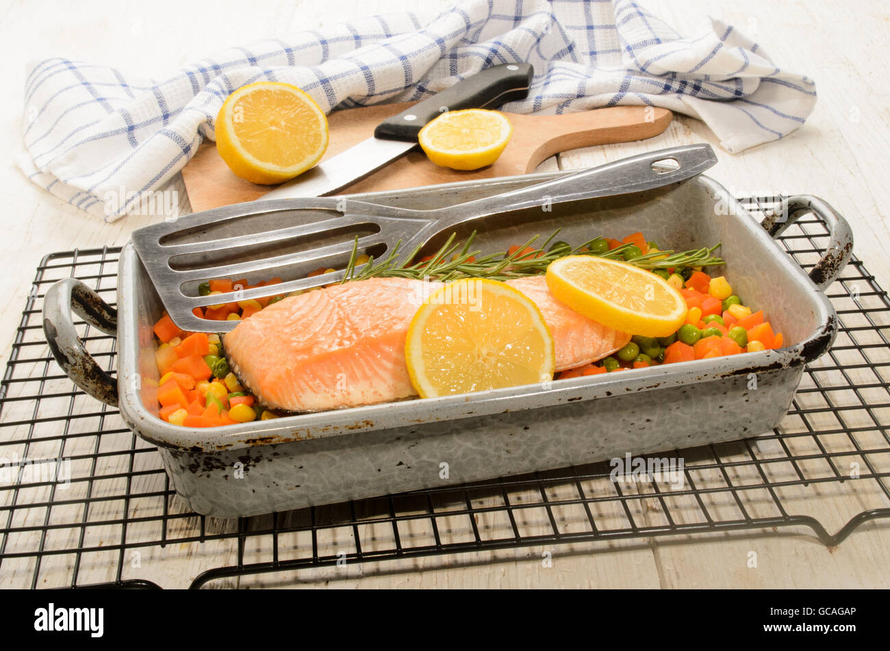 steamed salmon fillet on finely chopped vegetable in a serving tray