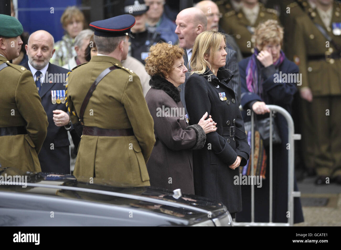 Captain Daniel Read's mother, Sally Webb (centre) holds the arm of Lorraine Read, wife of Captain Daniel Read, 31, of 11 Explosive Ordnance Disposal Regiment, Royal Logistic Corps at his funeral at Truro Cathedral, Cornwall. Stock Photo