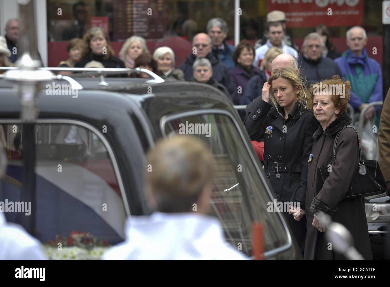 Captain Daniel Read's wife Lorraine Read (left) and Sally Webb, mother of Captain Daniel Read, 31, of 11 Explosive Ordnance Disposal Regiment, Royal Logistic Corps look at his coffin during his funeral at Truro Cathedral, Cornwall. Stock Photo