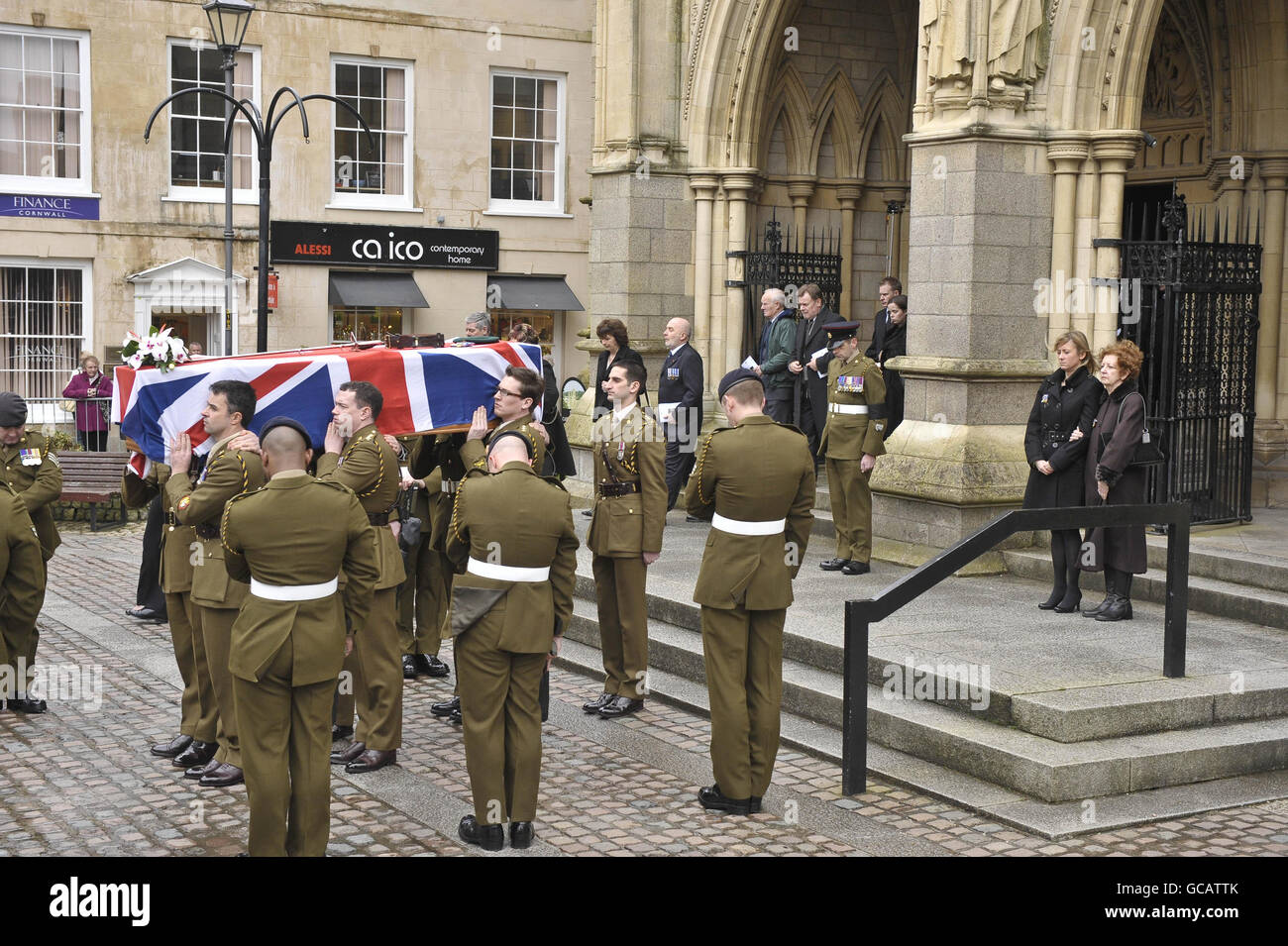 Captain Daniel Read's wife Lorraine Read (2nd right) and Sally Webb (right), mother of Captain Daniel Read, 31, of 11 Explosive Ordnance Disposal Regiment, Royal Logistic Corps as his coffin is carried from Truro Cathedral, Cornwall during his funeral. Stock Photo