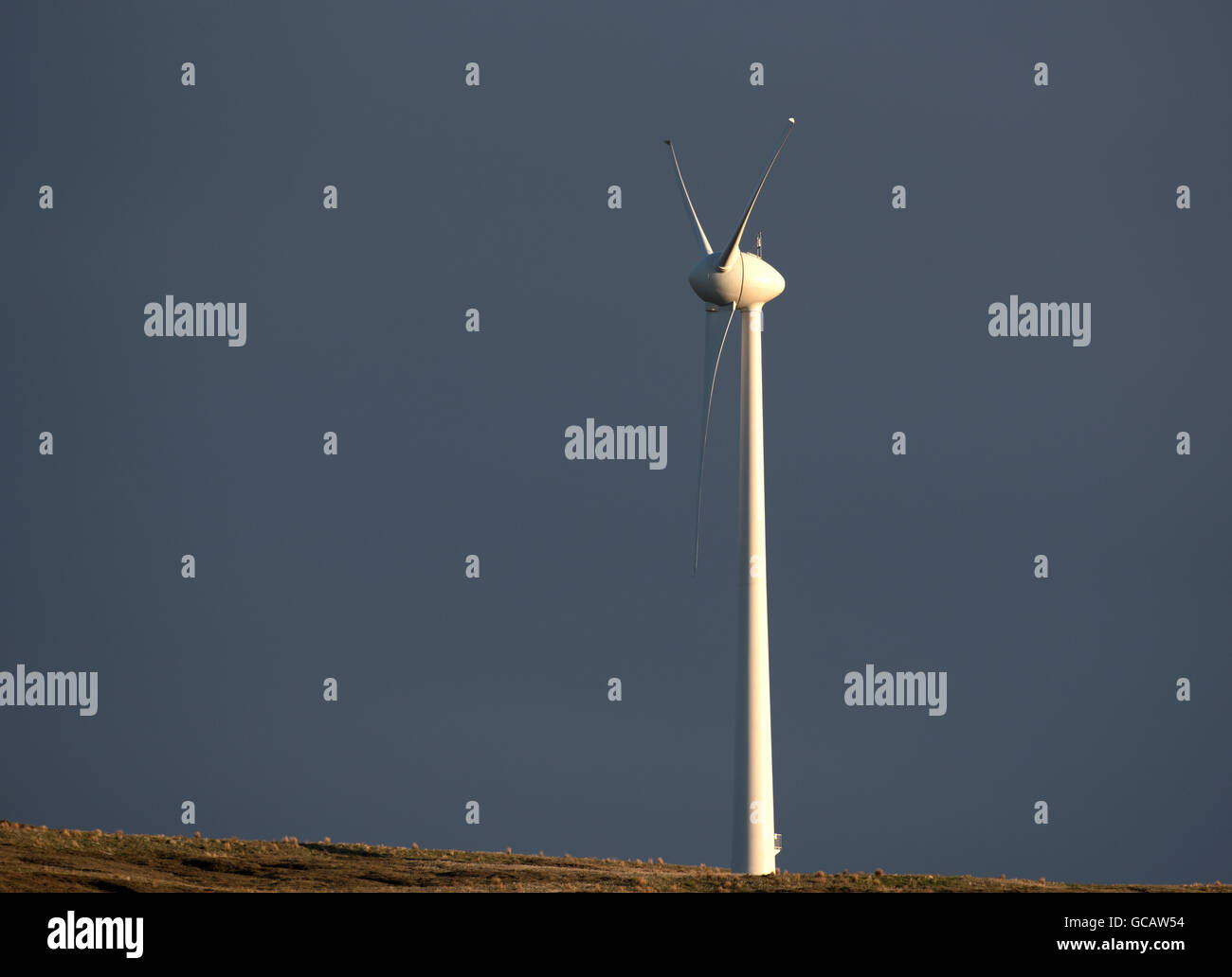 Lone wind turbine on the Orkney Isles providing electricity to the nearby community all year round. Stock Photo