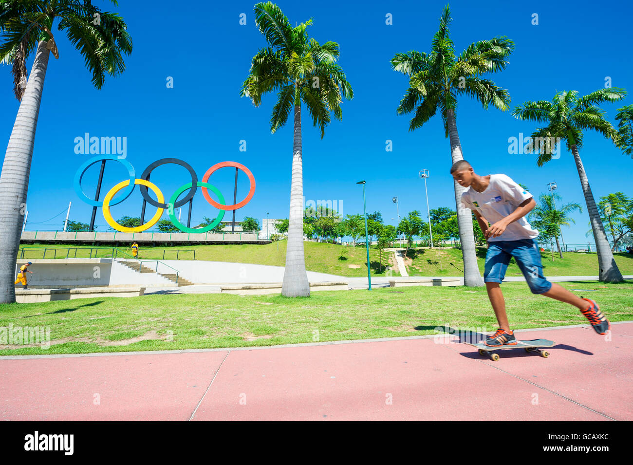 RIO DE JANEIRO - MARCH 18, 2016: A young skateboarder skates in front of Olympic rings installed for the 2016 Summer Games. Stock Photo