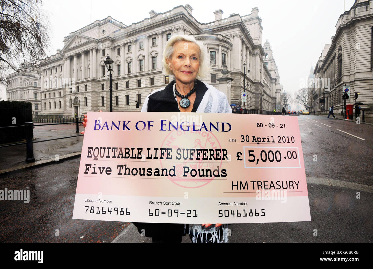 Honor Blackman holds a giant fake cheque near the Treasury, London. The actress is supporting the Equitable Members Action Group who are today holding news conference as part of their campaign urging the Government to help those who lost up to 50 per cent of their pensions with the near collapse of Equitable Life. Stock Photo