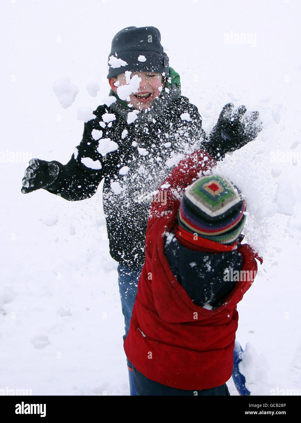 Daniel Egerton and his brother James from Bingham, Nottinghamshire enjoy playing in the snow. Stock Photo