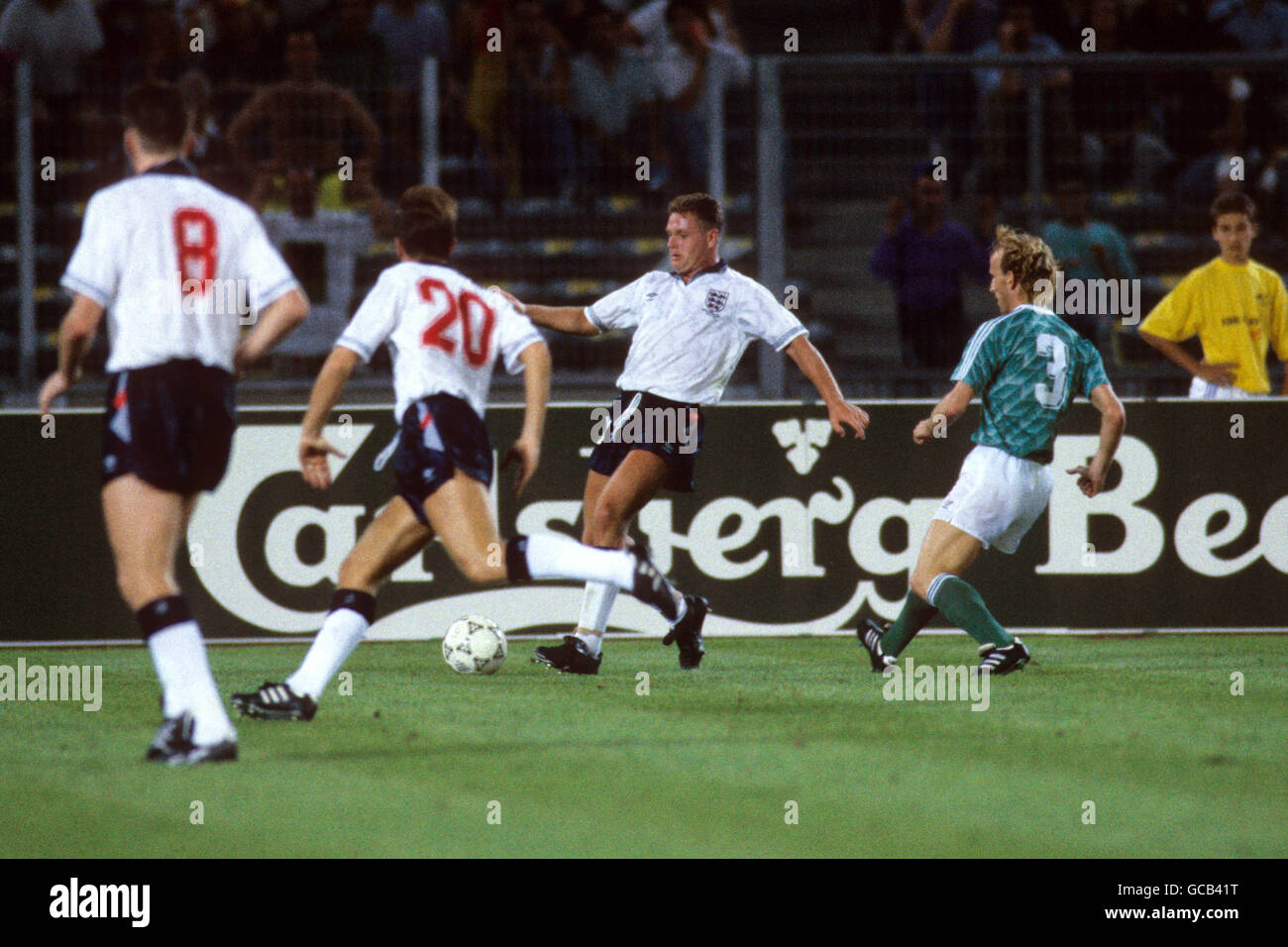 England's Paul Gascoigne (c) under pressure from West Germany's Andreas Brehme (r) Stock Photo