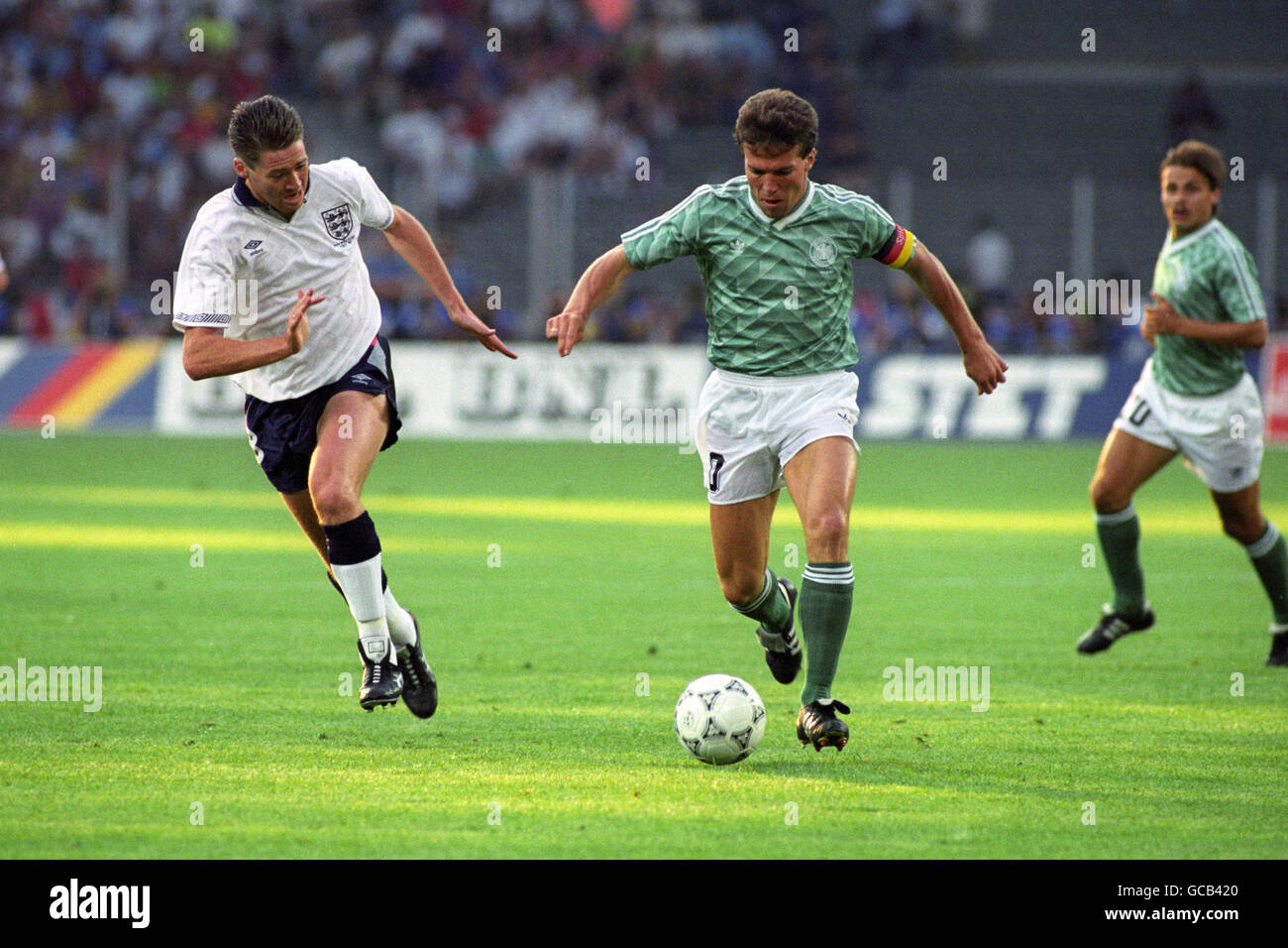 England's Chris Waddle (l) in action with West Germany captain Lothar Matthaeus (r) Stock Photo