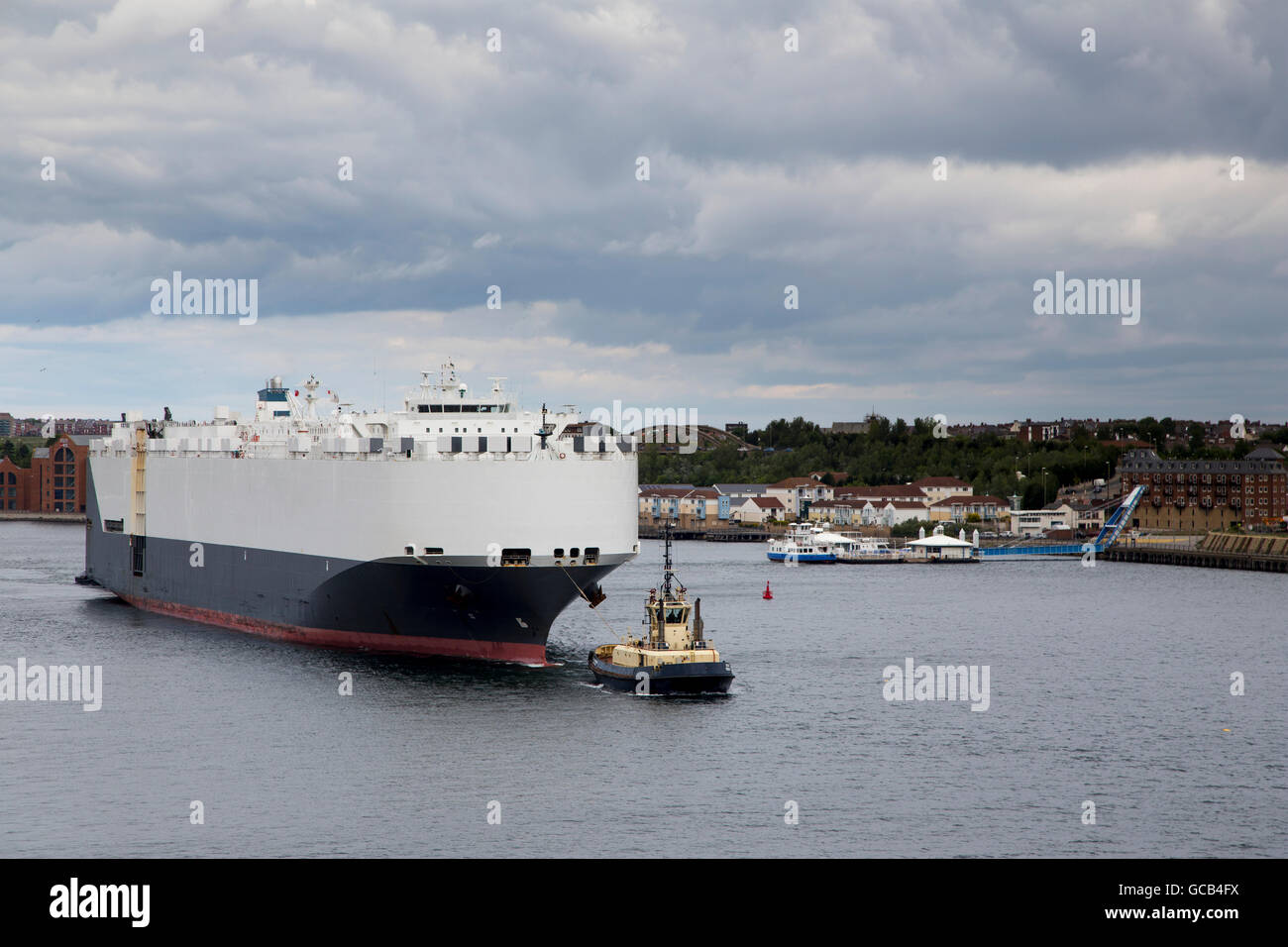 Tug boat guiding ship in port hi-res stock photography and images - Alamy